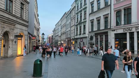 Wide-angle-shot-of-tourists-at-main-Square-of-the-Old-Town-of-Krakow-in-evening