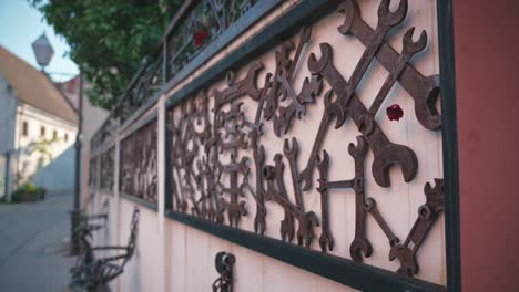 close-up-of-an-ornate-metal-fence-made-from-repurposed-tools-and-machinery-parts,-lining-a-street-in-Varaždin,-Croatia