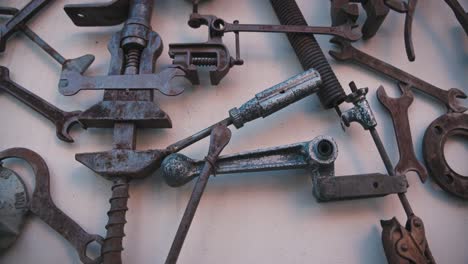 Close-up-of-various-repurposed-tools-and-industrial-materials-arranged-artistically-on-a-wall-in-Varaždin,-Croatia