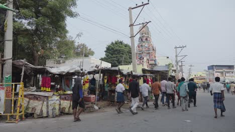 Wide-shot-of-a-group-of-young-Indian-men-walking-down-a-rural-street-in-India