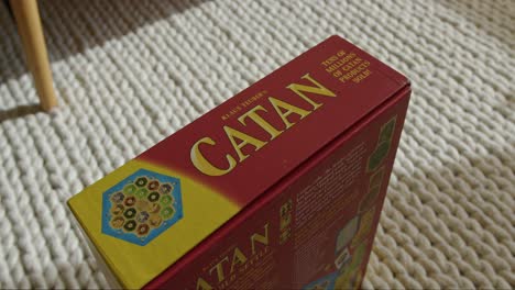 Close-Up-Tilt-Down-of-a-Catan-Board-Game-Box