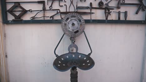 Artistic-metal-chair-made-from-repurposed-tools-and-machinery-parts,-displayed-against-a-wall-in-Varaždin,-Croatia