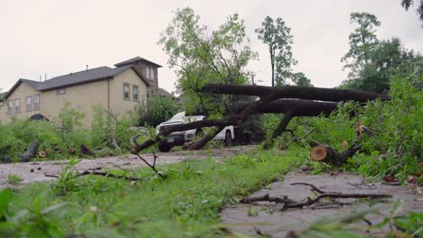 Trees-and-debris-partially-block-road-in-neighborhood-after-Hurricane-Beryl-strikes-Houston,-Texas