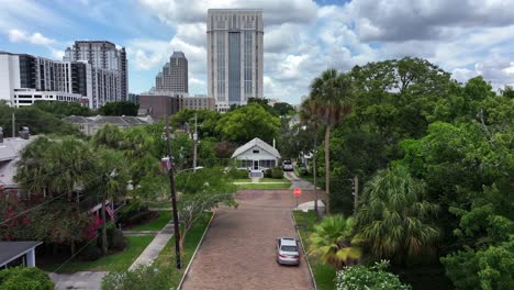 Aerial-forward-shot-of-street-with-palm-trees-in-quiet-housing-area-of-Orlando-City