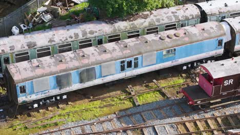 Aerial-view-looking-down-over-disused-decaying-train-carriages-in-Northamptonshire-ironstone-railroad-yard