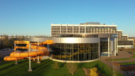 Veekeskus-water-park-and-Tervise-Paradiis-Spaa-Hotel-on-sunny-evening-in-aerial-parallax-view