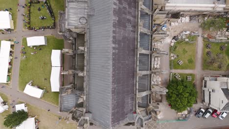 Top-down-aerial-view-of-the-roof-of-Exeter-City-Cathedral,-showcasing-the-intricate-design-and-gothic-architecture-in-Devon,-UK,-July-2024