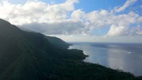 Morning-sunrise-clouds-volcano-island-mountains-Teahupoo-Tahiti-aerial-drone-French-Polynesia-South-Pacific-surf-wave-reef-channel-WSL-surfing-Olympic-venue-up-the-coastline-coral-reef-forward-motion