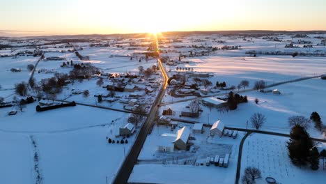 Aerial-winter-landscape-with-farm-houses-and-rural-road-in-american-suburb