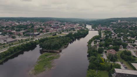 Calm-Waters-Of-Magog-River-In-Sherbrooke,-Canada---Drone-Shot