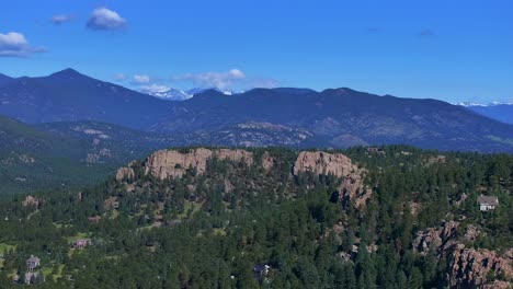 Evergreen-Colorado-aerial-drone-Front-Range-Rocky-Mountains-homes-neighborhood-landscape-Spring-Summer-morning-North-Turkey-Creek-Marshdale-sunny-forward-pan-up-reveal-motion