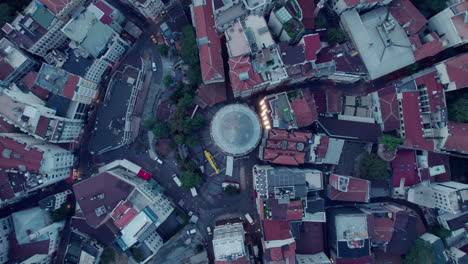 Birdseye-drone-flight-spinning-over-the-Galata-tower-and-the-city-around-of-Istanbul-on-a-grey-day,-slow-motion