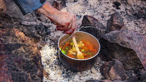 Cooking-Vegetable-Stew-And-Boiling-Water-In-Kettle-Outdoors-at-Campground