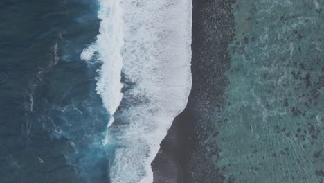 Waves-crashing-mid-colorful-aqua-turquoise-shallow-coral-reef-Teahupoo-Tahiti-aerial-drone-birdseye-view-perspective-French-Polynesia-surf-wave-Pacific-Ocean-Channel-Point-Faremahora-Pass-Havae-still