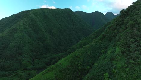 Teahupoo-Tahiti-valley-high-altitude-mountain-peaks-hills-sunrise-aerial-drone-view-French-Polynesia-yellow-clouds-golden-hour-sunset-WSL-Surfing-summer-Olympic-venue-town-village-coast-forward-pan