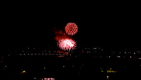 Fireworks-In-Night-Sky-In-Belmont-Park,-San-Diego,-California---Aerial-Pullback