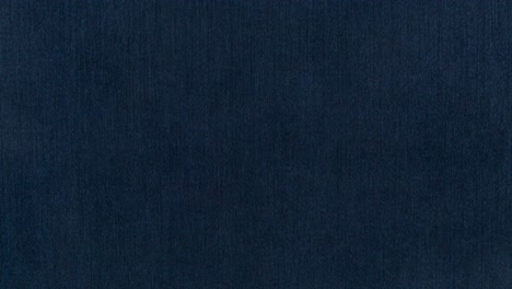 Camera-slowly-zooms-in-on-dark-blue-wool-texture-in-a-photography-studio