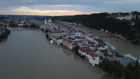 Old-city-center-Passau-aerial-sunset-at-flood-of-Danube-river-Inn