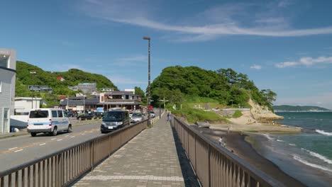 POV-walking-along-coastline-in-Kamakura-with-traffic-and-ocean