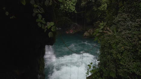 Puente-de-Dios-waterfall-with-turquoise-water-in-Mexico-rainforest,-aerial