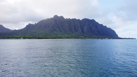 An-awe-inspiring-aerial-shot-capturing-the-grandeur-of-a-towering-mountain-range-against-the-backdrop-of-a-serene-ocean