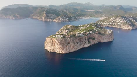 Aerial-view-of-small-scattered-limestone-islands-and-boat-in-water,-Mallorca