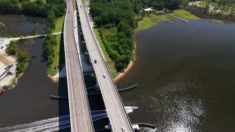 Motorboat-Cruising-Under-West-Bay-Bridge-In-Panama-City-Beach,-Florida