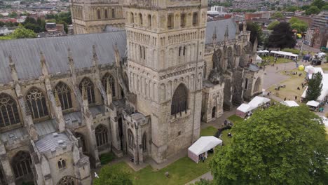 Orbital-view-of-Exeter-Cathedral-with-market,-capturing-the-vibrant-atmosphere-and-historic-architecture-in-Devon,-UK,-July-2024