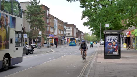 View-of-Sidwell-St-with-shops,-pedestrians,-and-vehicles,-Exeter,-Devon,-UK,-June-2024