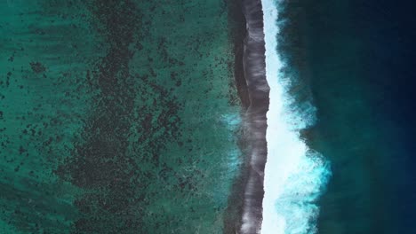 Waves-crashing-mid-colorful-aqua-turquoise-shallow-coral-reef-Teahupoo-Tahiti-aerial-drone-birdseye-view-perspective-French-Polynesia-surf-wave-Pacific-Ocean-Channel-Point-Faremahora-Pass-Havae-upward