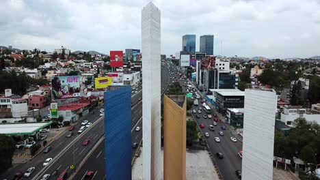 Top-close-up-shot-of-the-Satélite-towers,-on-the-outskirts-of-Mexico-City,-while-the-drone-crosses-them-in-a-south-north-direction