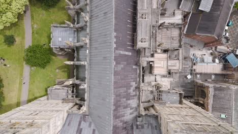 Aerial-view-of-roof-restoration-works-with-scaffolding-on-Exeter-City-Cathedral,-highlighting-the-meticulous-preservation-in-Devon,-UK,-July-2024