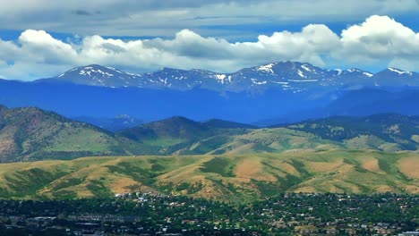 Summer-Denver-Colorado-aerial-drone-parallax-Golden-Arvada-Lakewood-sunny-front-range-foothills-landscape-Mount-Blue-Sky-Red-Rocks-Amphitheater-neighborhood-homes-clouds-backwards-pan-reveal