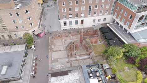 Aerial-view-of-the-ancient-ruins-of-St-Catherine's-Chapel,-nestled-amidst-the-modern-buildings-of-Exeter,-Devon,-UK,-July-2024