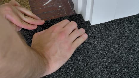 Carpet-tile-trim-being-fitted-to-doorframe