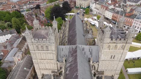 Drone-flyover-showcasing-the-magnificent-Exeter-Cathedral-in-the-historic-city-of-Exeter,-Devon,-UK,-July-2024