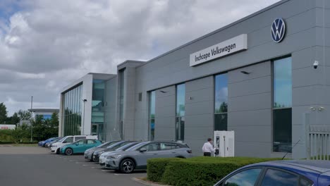 Exterior-of-Volkswagen-dealership-with-cars-parked-outside,-Exeter,-Devon,-UK,-June-2024