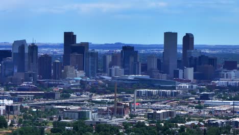 Summer-downtown-Denver-city-skyscrapers-Colorado-aerial-drone-traffic-cars-highway-Mile-High-neighborhood-homes-blue-skies-cloudy-6th-avenue-colfax-RTD-line-front-range-foothills-landscape-upward-jib