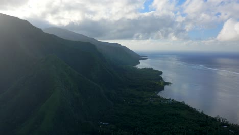 Morning-sunrise-clouds-volcano-island-mountains-Teahupoo-Tahiti-aerial-drone-French-Polynesia-South-Pacific-surf-wave-reef-channel-WSL-surfing-Olympic-venue-up-the-coastline-coral-reef-circle-right