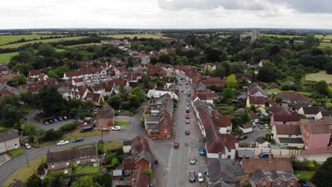 Drone-shot-of-the-high-street-in-Lavenham-which-is-a-well-preserved-medieval-village-in-Suffolk,-UK