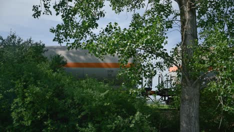 VTG-gas-rail-tank-car-in-train-composition-through-Vojvodina-countryside-landscape