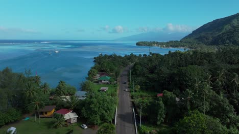 Teahupoo-Tahiti-French-Polynesia-aerial-drone-view-road-van-car-up-island-coast-to-Papeete-morning-sunny-sunshine-bay-channel-coral-reef-mountains-traffic-roadtrip-drive-forward-pan-up