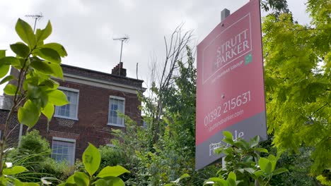 Grand-townhouse-with-For-Sale-estate-agent-sign-outside,-showcasing-residential-architecture,-Exeter-Devon-UK,-June-2024