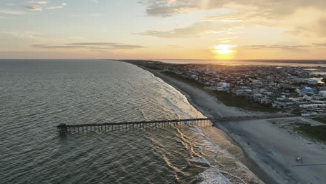 Epic-drone-shot-of-sun-setting-over-Atlantic-Beach-North-Carolina,-slow-panning-shot