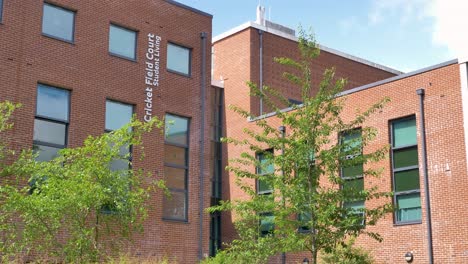 Exterior-of-student-accommodation-buildings-with-modern-red-brick-design,-Exeter,-Devon,-UK,-June-2024