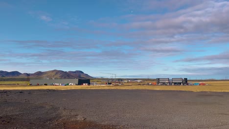 Industrial-worksite-by-volcanic-mountains-in-rural-Iceland,-static