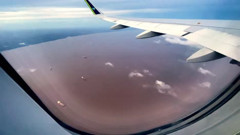 Brazil,-Pará:-Incredible-view-of-the-Amazon-River-from-inside-an-airplane,-showcasing-the-vast,-winding-waters-and-lush-rainforest-below