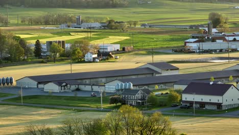 Rural-farmland-with-animal-barns-and-rolling-hills-with-fields