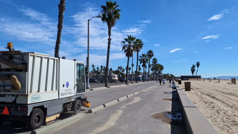 Street-cleaning-machine,-Venice-Beach-walking-path-at-beach,-Los-Angeles,-USA