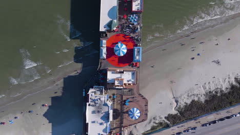 Top-down-drone-shot-above-the-Galveston-Island-Historic-Pleasure-Pier,-in-sunny-USA